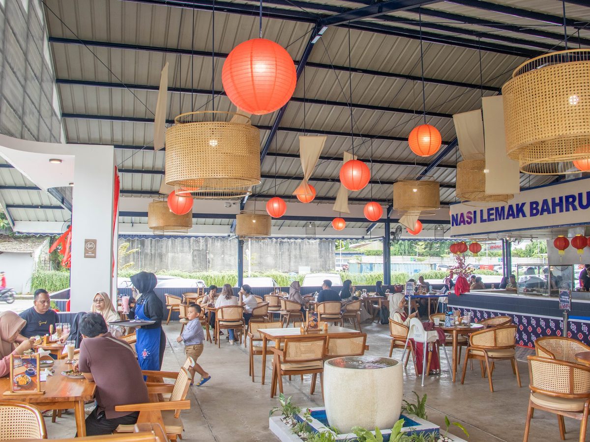 Guests dining under red lanterns and blossom